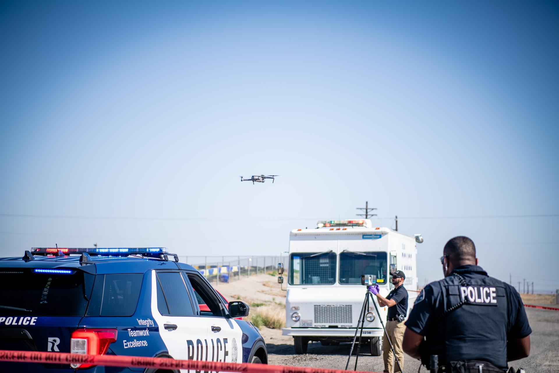 Two Richland Police cars operating a drone