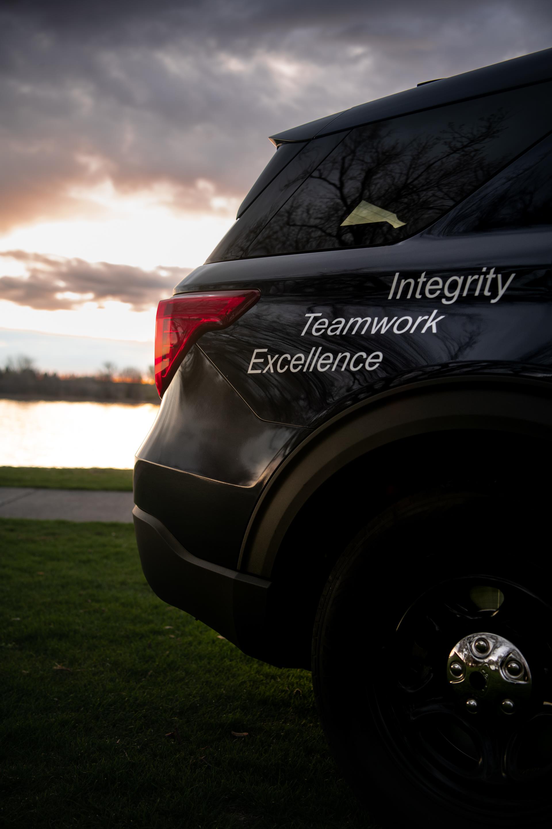 Police Car with written values of integrity, teamwork and excellence